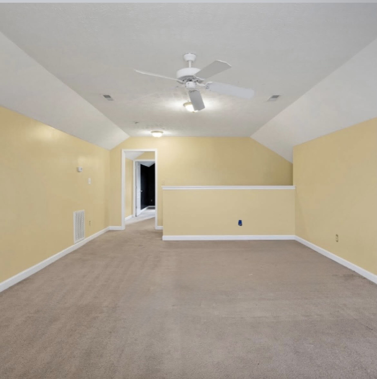 Bonus room with sloped ceilings and half wall