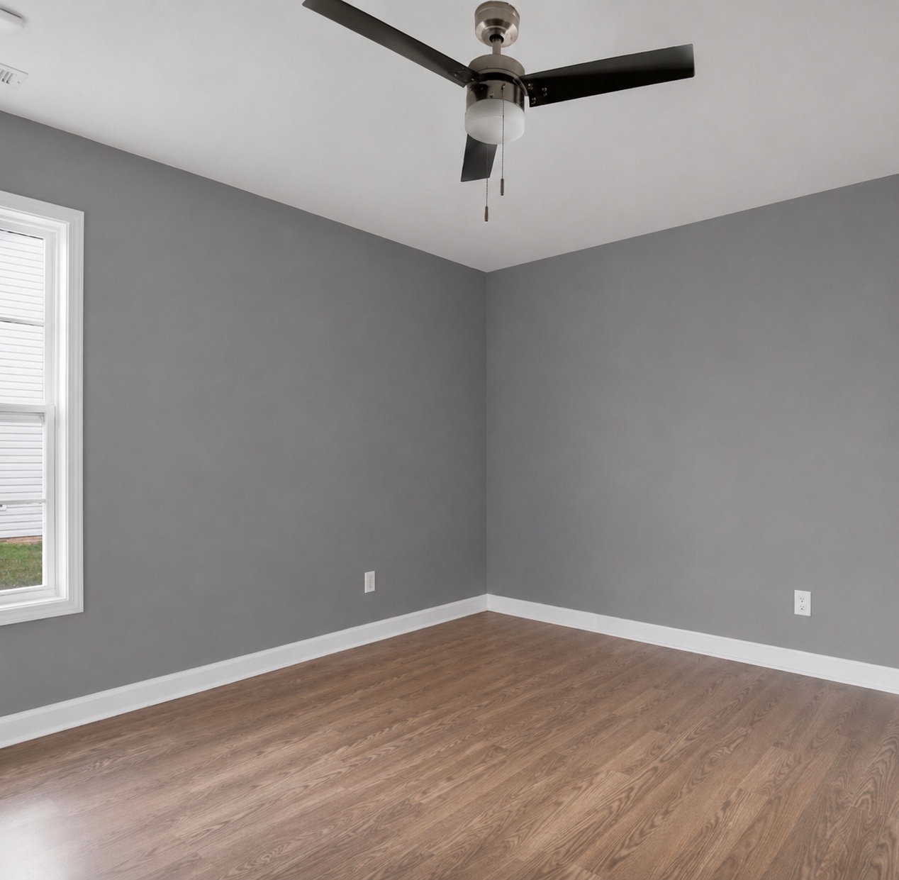 Room with window and wood-look flooring