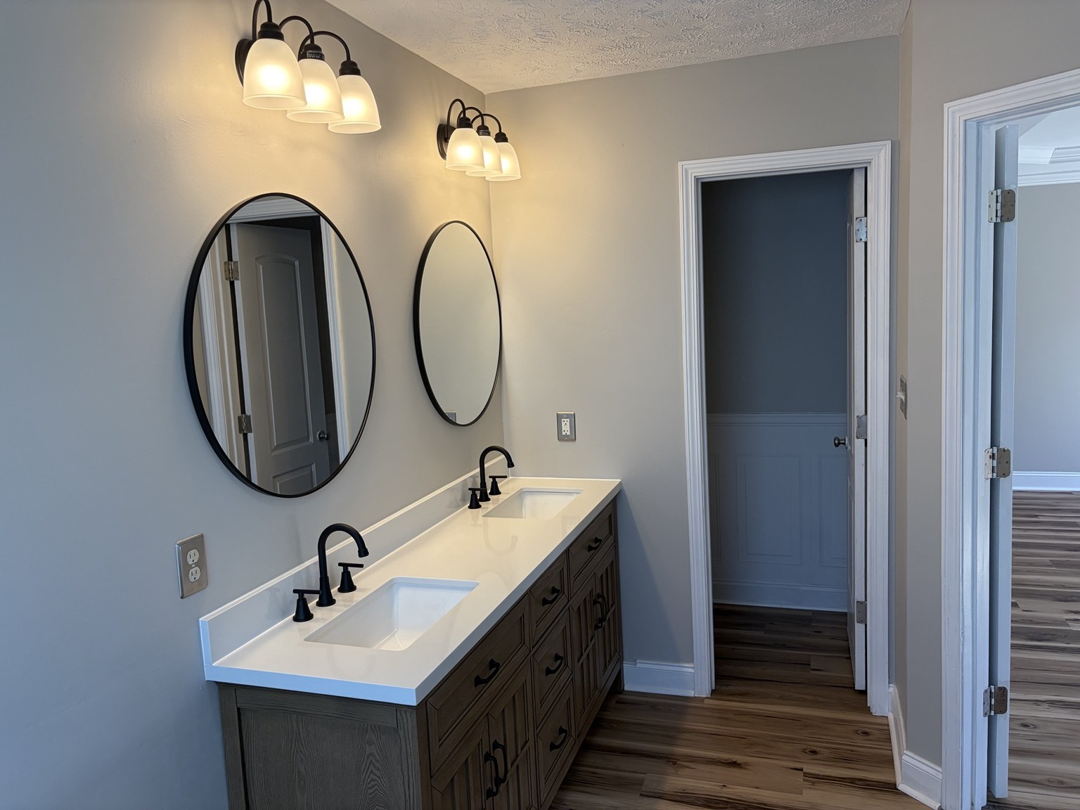 Bathroom vanity with two sinks and two oval mirrors