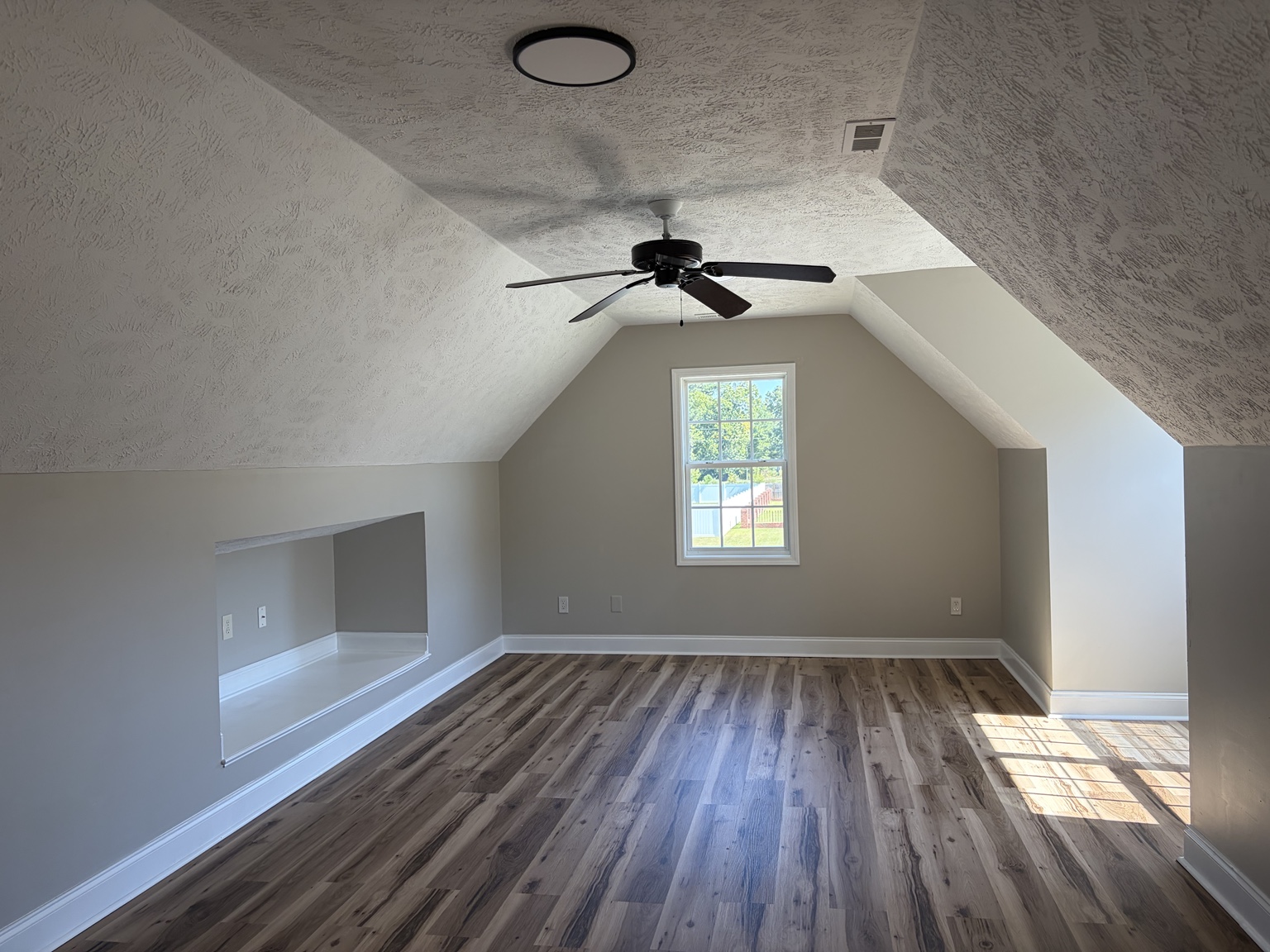 Bonus space with sloped ceilings and a recessed nook