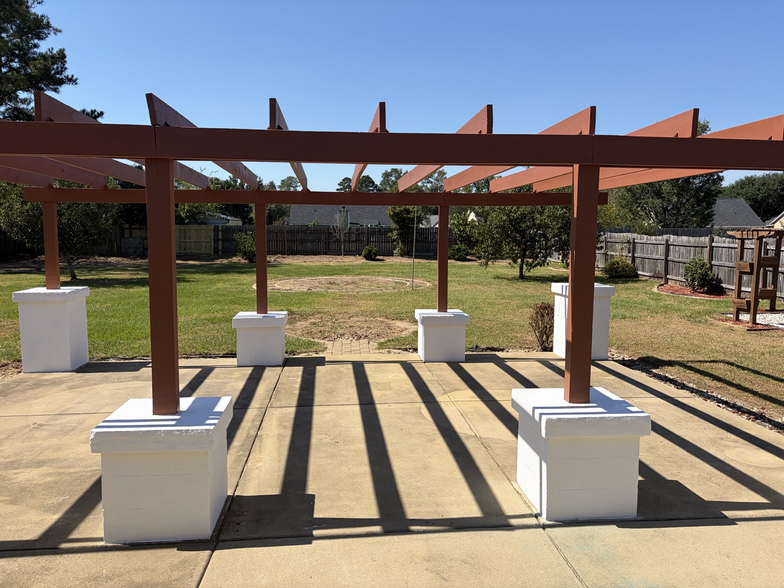 Pergola above a patio facing the backyard